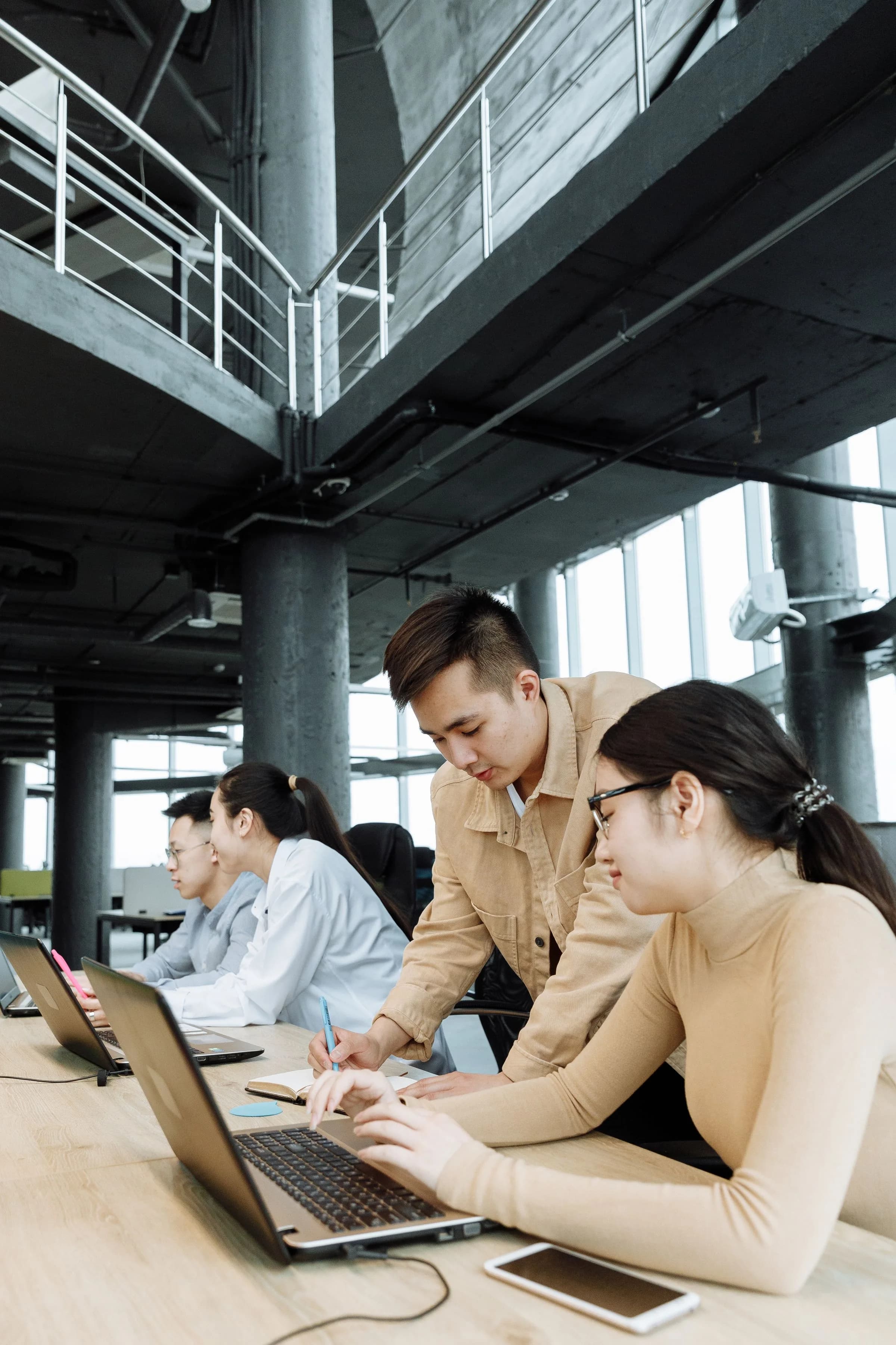 Colleagues collaborating over a laptop in a shared office