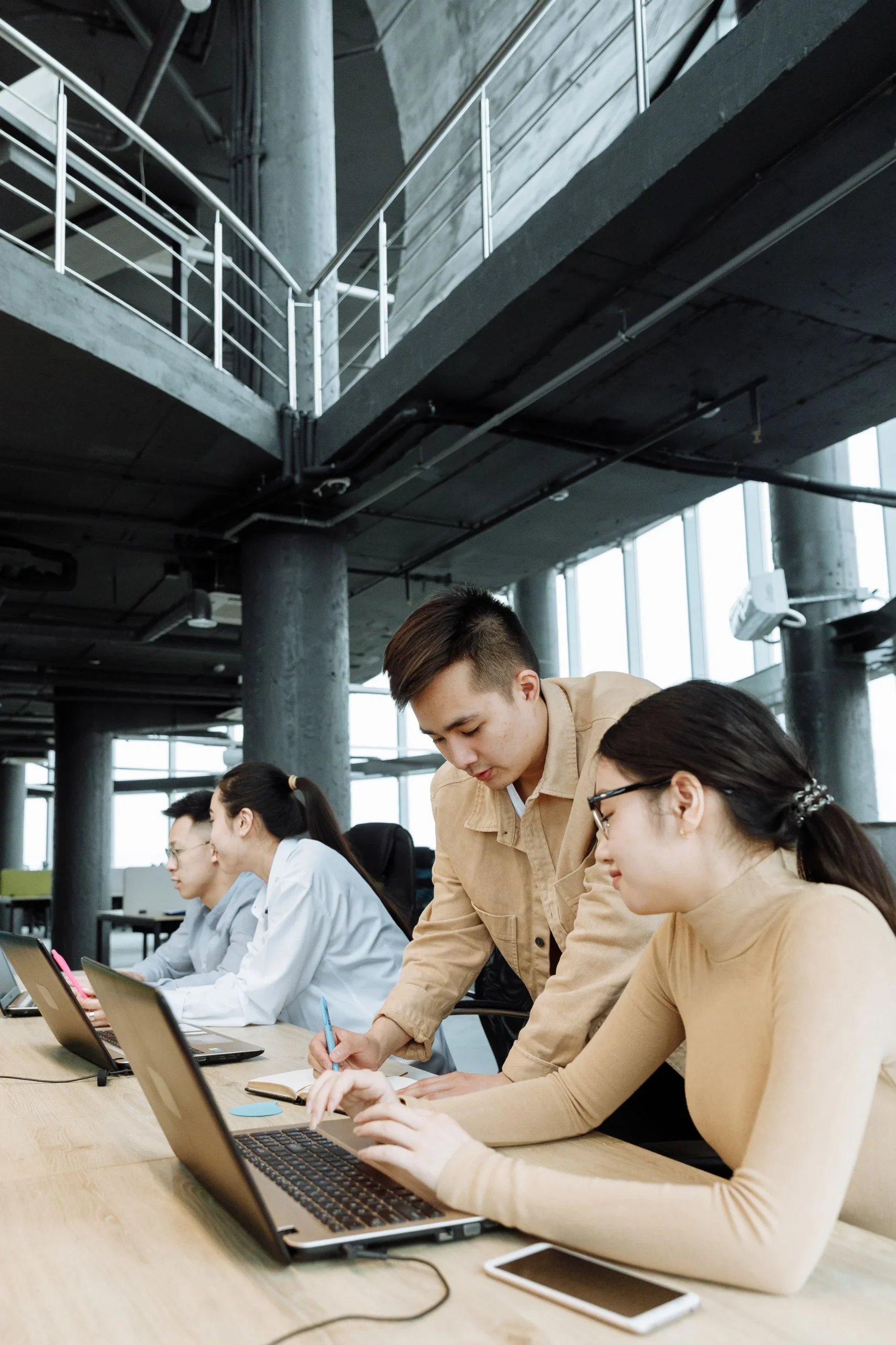 Colleagues collaborating over a laptop in a shared office